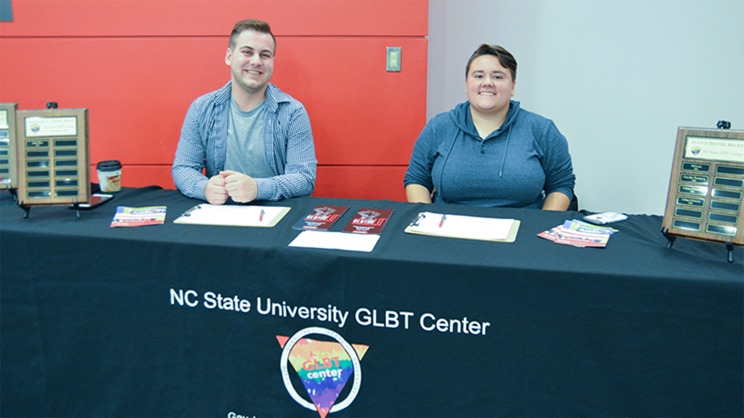 Students at a table that says GLBT Center