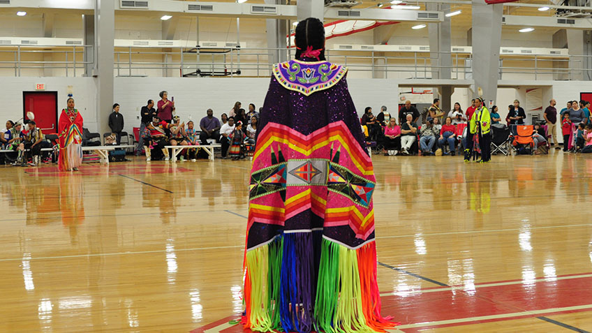 Woman in Native Dress in Carmichael Gym - Powwow