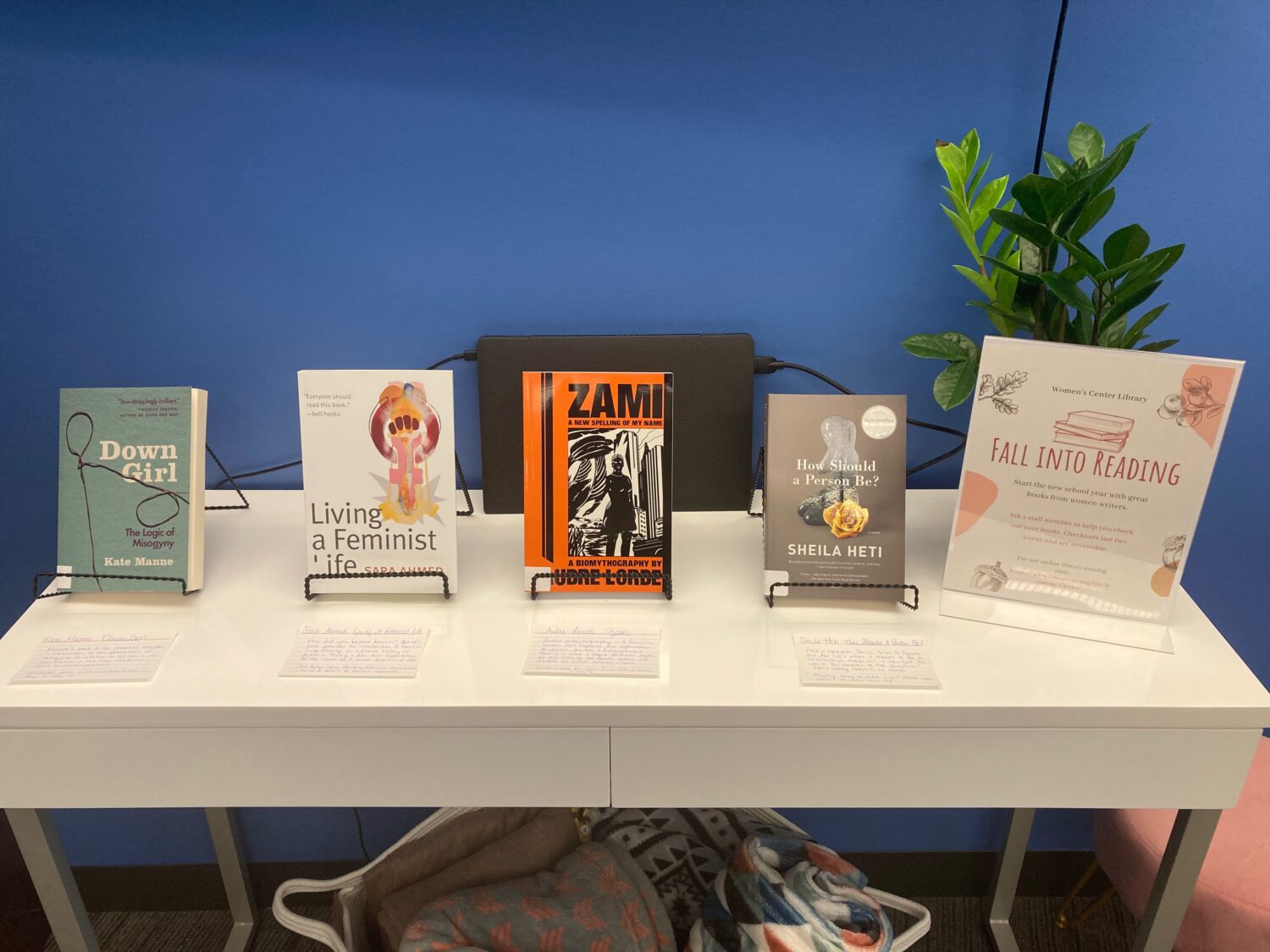 table with feminist books on top