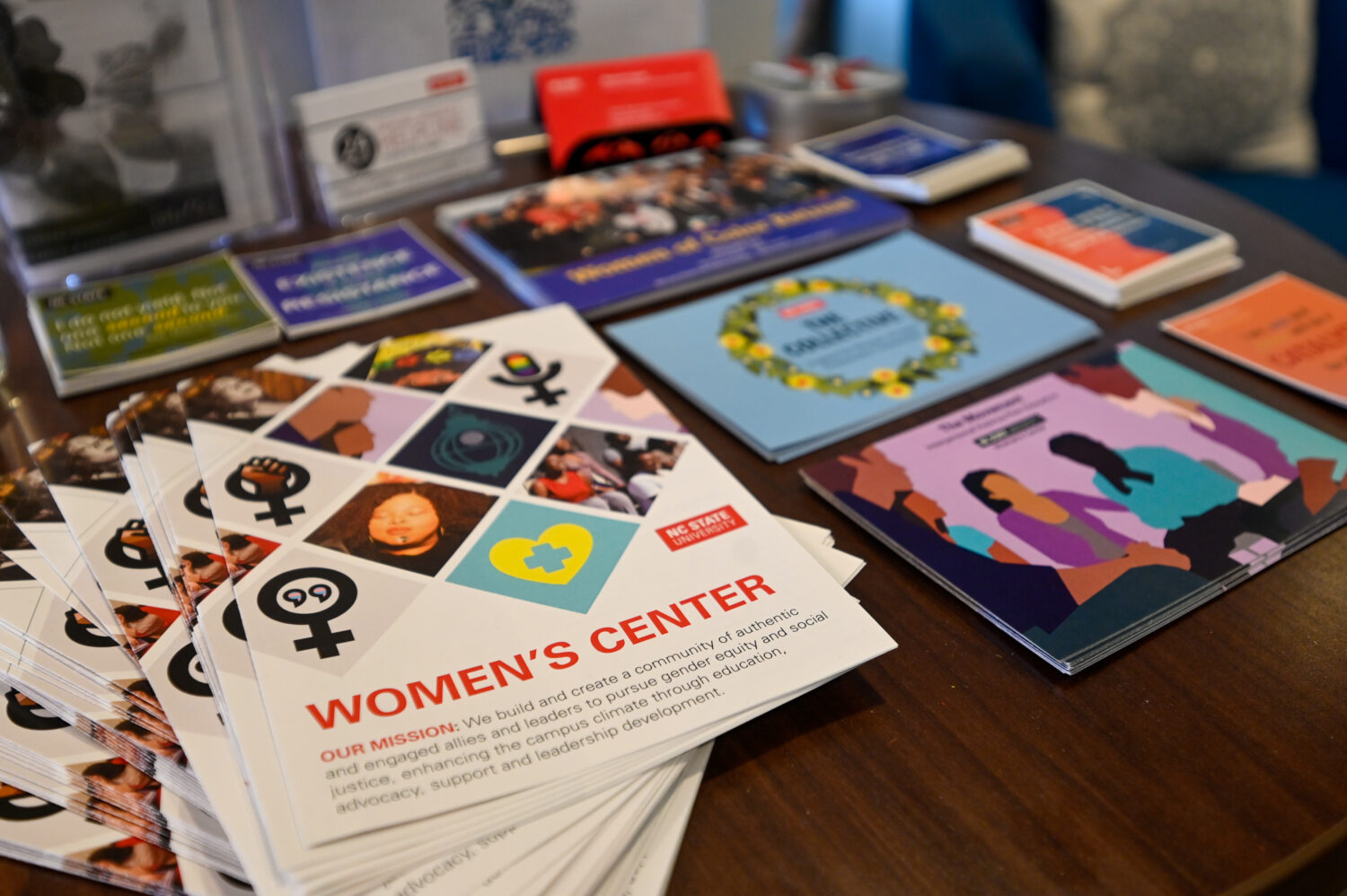 Women's Center brochures, postcards, and stickers on a table