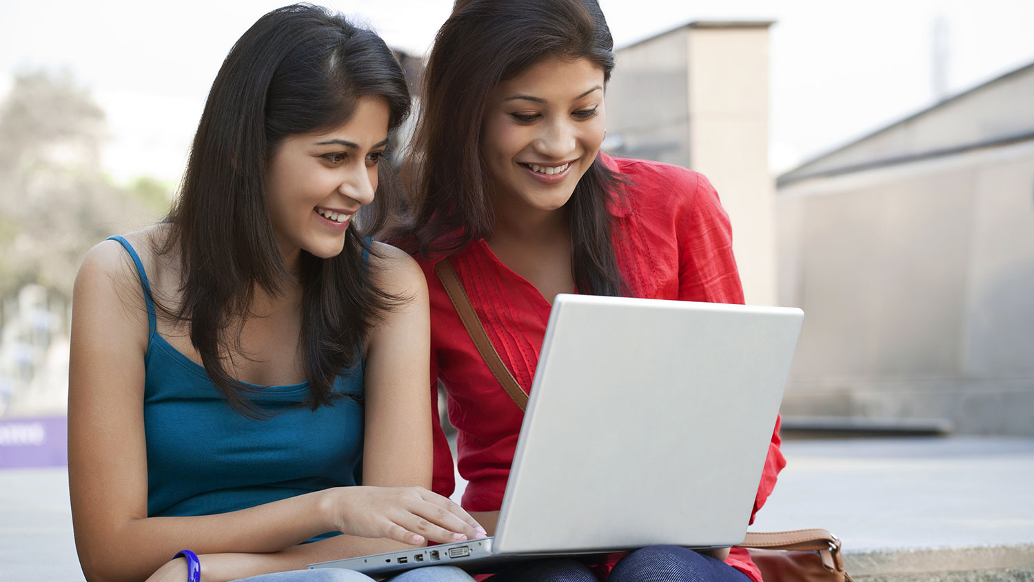 Two students looking at laptop